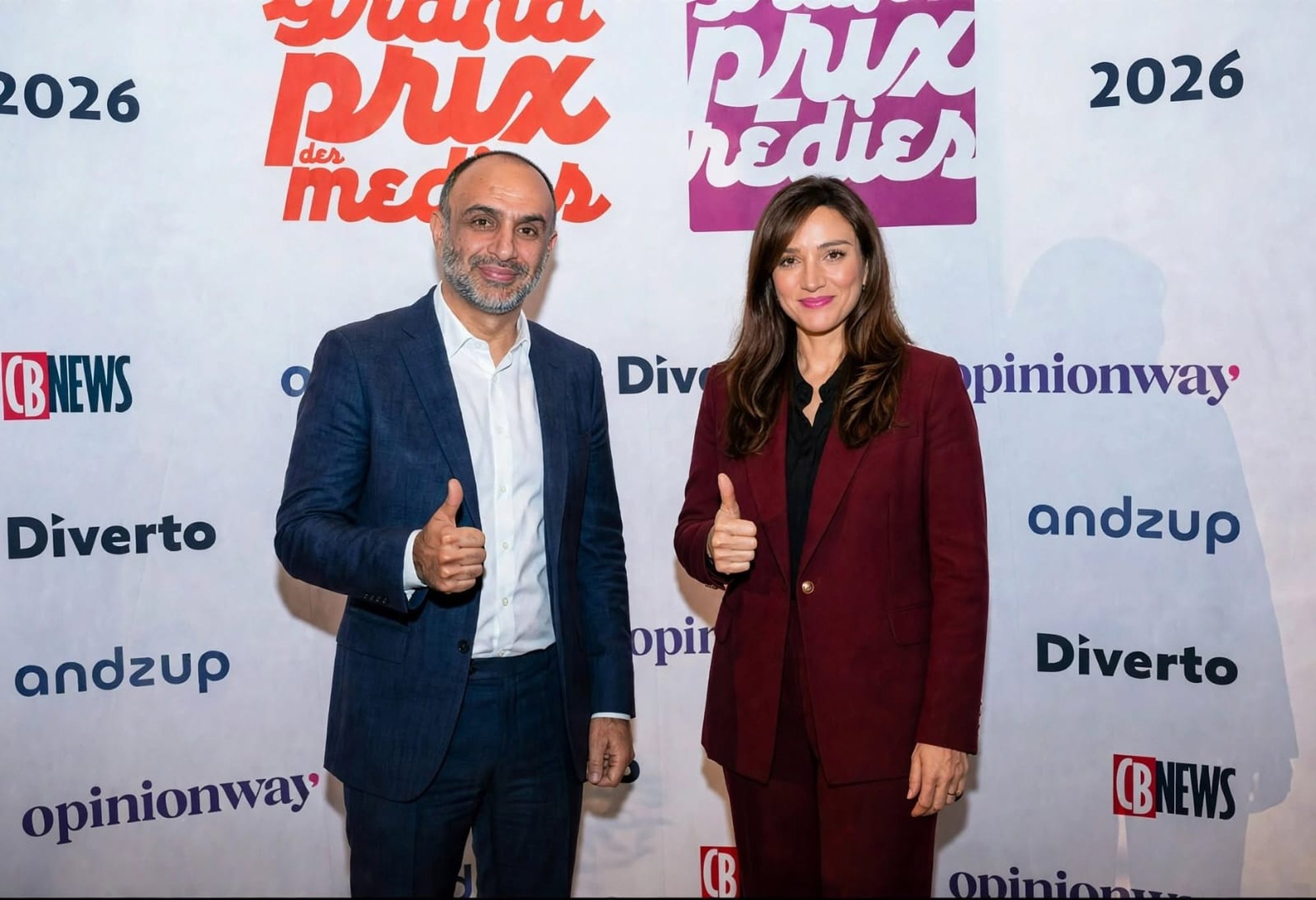Two people at the Grand Prix des Médias 2026 photocall
